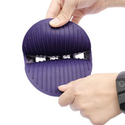 Person holding a purple massaging pet shampoo brush with ergonomic design and soft bristles for grooming.